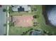 Overhead shot of home, showcasing roof, yard, landscaping, and pond at 1745 Hyssop Loop, North Port, FL 34289