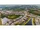 Overhead shot of a community showcasing beautiful homes surrounding winding lakes and mature trees at 1745 Hyssop Loop, North Port, FL 34289