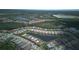 Aerial view of a residential neighborhood with lush greenery and water features at 1745 Hyssop Loop, North Port, FL 34289