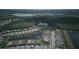 An aerial view of a quiet community surrounding lush green spaces, tranquil ponds, and mature trees at 1745 Hyssop Loop, North Port, FL 34289