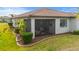 The backyard features well-maintained landscaping and a covered patio area, perfect for enjoying the outdoors at 1745 Hyssop Loop, North Port, FL 34289