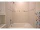 The serene bathroom features a pristine bathtub, with a refreshing showerhead for a tranquil experience at 1745 Hyssop Loop, North Port, FL 34289