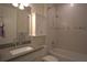 A well-lit bathroom features a sleek vanity, a built-in cabinet, and a shower-tub combo at 1745 Hyssop Loop, North Port, FL 34289