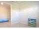 Bedroom features a neutral wall and trim, plus a tiled floor in the entry at 1745 Hyssop Loop, North Port, FL 34289