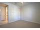 Bedroom with neutral carpet and trim features a ceiling fan and closet with sliding doors at 1745 Hyssop Loop, North Port, FL 34289