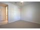 Cozy bedroom featuring neutral carpet, ample closet space, and an adjacent bathroom at 1745 Hyssop Loop, North Port, FL 34289