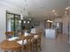 Open concept dining and living areas, featuring a dining table and comfortable seating at 1745 Hyssop Loop, North Port, FL 34289