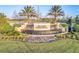 Beautifully landscaped entrance to Del Webb Cypress Falls with a cascading water feature at 1745 Hyssop Loop, North Port, FL 34289
