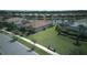 Aerial view of house with lush green lawn, brick driveway, and well-manicured landscaping at 1745 Hyssop Loop, North Port, FL 34289