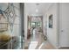 Inviting foyer with archways, neutral tones, decorative glass door, and elegant console table at 1745 Hyssop Loop, North Port, FL 34289