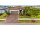 Charming single-story home featuring a brick driveway, well-manicured landscaping, and a neutral color scheme at 1745 Hyssop Loop, North Port, FL 34289