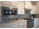 Modern kitchen with white cabinetry, stainless steel appliances, and tile backsplash at 1745 Hyssop Loop, North Port, FL 34289