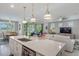 Open concept kitchen with white cabinetry, granite countertops, and stainless steel appliances at 1745 Hyssop Loop, North Port, FL 34289