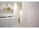 Bright laundry room with modern appliances, shelving, and plenty of storage space at 1745 Hyssop Loop, North Port, FL 34289