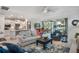 Bright, open-concept living room flowing to the kitchen and dining areas with stunning lake views at 1745 Hyssop Loop, North Port, FL 34289