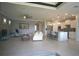 Open concept living room and kitchen with tile floors, high ceilings, and natural light at 1745 Hyssop Loop, North Port, FL 34289