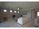 Well-lit living area with neutral tones, tile floors, and a comfortable seating arrangement at 1745 Hyssop Loop, North Port, FL 34289