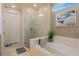 Contemporary main bathroom featuring a soaking tub and frameless glass shower at 1745 Hyssop Loop, North Port, FL 34289