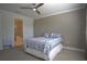 The main bedroom showcases neutral colors and includes an en suite bath, and breezy ceiling fan at 1745 Hyssop Loop, North Port, FL 34289