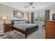 Serene main bedroom suite with a large window, ceiling fan, and a cozy atmosphere at 1745 Hyssop Loop, North Port, FL 34289