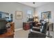 Comfortable office features a large desk, a plush leather chair, and natural light from a window at 1745 Hyssop Loop, North Port, FL 34289