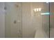 The renovated shower features sleek glass doors, a comfortable built-in bench, and an elegant tiled design at 1745 Hyssop Loop, North Port, FL 34289