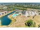 Aerial view of the community, highlighting the pool, lake, and tennis courts at 175 Kings Hwy # 1114, Punta Gorda, FL 33983