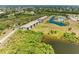 Aerial view showcasing the community's landscaping, tennis courts and pond at 175 Kings Hwy # 1114, Punta Gorda, FL 33983