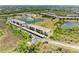 An overhead view of the condo buildings, ponds, parking, and green landscaping at 175 Kings Hwy # 1114, Punta Gorda, FL 33983
