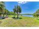 Picturesque backyard overlooking a peaceful lake and a palm tree at 175 Kings Hwy # 1114, Punta Gorda, FL 33983