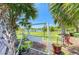 Relaxing backyard with a swing set, chairs, and a view of the lake at 175 Kings Hwy # 1114, Punta Gorda, FL 33983