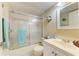 Cozy bathroom with shower, a white sink with marble countertop, and decorative wall art at 175 Kings Hwy # 1114, Punta Gorda, FL 33983