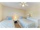 Bedroom featuring two twin beds, ceiling fan and dresser at 175 Kings Hwy # 1114, Punta Gorda, FL 33983