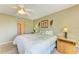 Bright bedroom with a ceiling fan, carpeted floors, and walk-in closet at 175 Kings Hwy # 1114, Punta Gorda, FL 33983