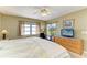 Bright bedroom featuring a ceiling fan, a window, and a sliding glass door to the outside at 175 Kings Hwy # 1114, Punta Gorda, FL 33983