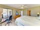 Bright bedroom with carpeted floors, ceiling fan, desk, and walk out access to the outdoor patio at 175 Kings Hwy # 1114, Punta Gorda, FL 33983
