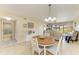 Dining area in an open layout, connecting the kitchen and living spaces with a table and chairs at 175 Kings Hwy # 1114, Punta Gorda, FL 33983