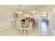 Dining area with a chandelier and seating for four adjacent to the kitchen and living area at 175 Kings Hwy # 1114, Punta Gorda, FL 33983