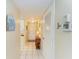 Hallway with tile flooring, thermostat, and coat closet, leading to the front door at 175 Kings Hwy # 1114, Punta Gorda, FL 33983