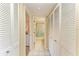 Hallway showing closet space and a doorway to the bathroom with shower at 175 Kings Hwy # 1114, Punta Gorda, FL 33983