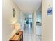 Bright condo hallway leading into the living spaces with neutral decor and tiled flooring at 175 Kings Hwy # 1114, Punta Gorda, FL 33983