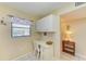 Bright office nook with a desk, chair, overhead cabinets, and natural light at 175 Kings Hwy # 1114, Punta Gorda, FL 33983