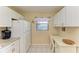 Bright office nook with a desk, chair, overhead cabinets, and natural light at 175 Kings Hwy # 1114, Punta Gorda, FL 33983