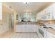 Spacious kitchen with white cabinets, granite countertops, and tile flooring at 175 Kings Hwy # 1114, Punta Gorda, FL 33983