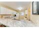 Bright kitchen features white cabinets, granite countertops, and modern appliances at 175 Kings Hwy # 1114, Punta Gorda, FL 33983