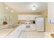Well-lit kitchen with white cabinets, granite countertops, and stainless steel sink at 175 Kings Hwy # 1114, Punta Gorda, FL 33983