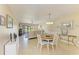 Open-concept living and dining area features neutral tones, tiled floors, and a view of the outdoors at 175 Kings Hwy # 1114, Punta Gorda, FL 33983