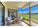 Well-lit screened patio with outdoor seating and tranquil green views at 175 Kings Hwy # 1114, Punta Gorda, FL 33983