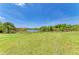 Peaceful view of a community pond surrounded by natural vegetation and a grassy lawn at 175 Kings Hwy # 1114, Punta Gorda, FL 33983