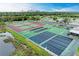 Aerial view of tennis and shuffleboard courts near the community parking lot at 175 Kings Hwy # 1114, Punta Gorda, FL 33983